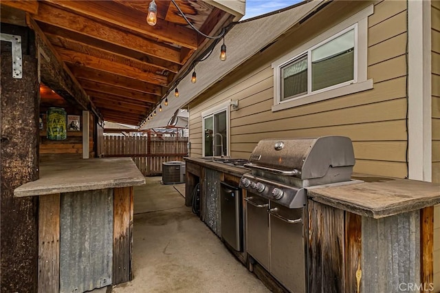 view of patio / terrace featuring cooling unit, fence, a grill, and an outdoor kitchen