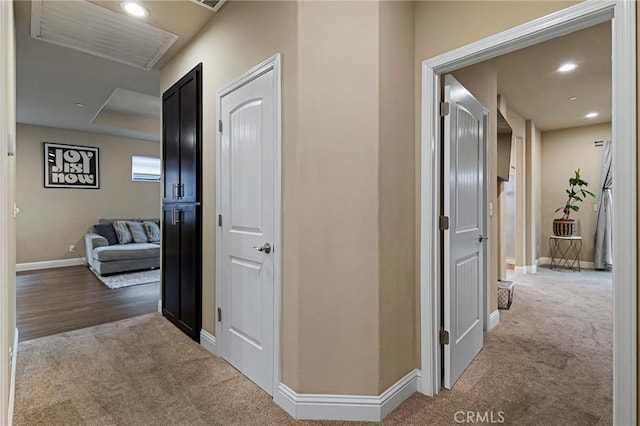 hall with recessed lighting, baseboards, and light carpet
