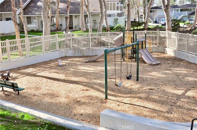 community jungle gym featuring a residential view and fence