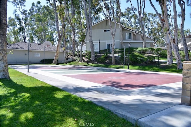 view of community featuring a lawn and community basketball court