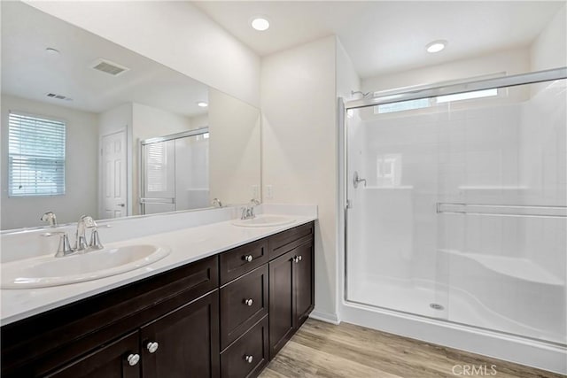 9126 Foster Ln, Chatsworth, CA 91311 - full bathroom with a stall shower, double vanity, plenty of natural light, and wood finished floors
