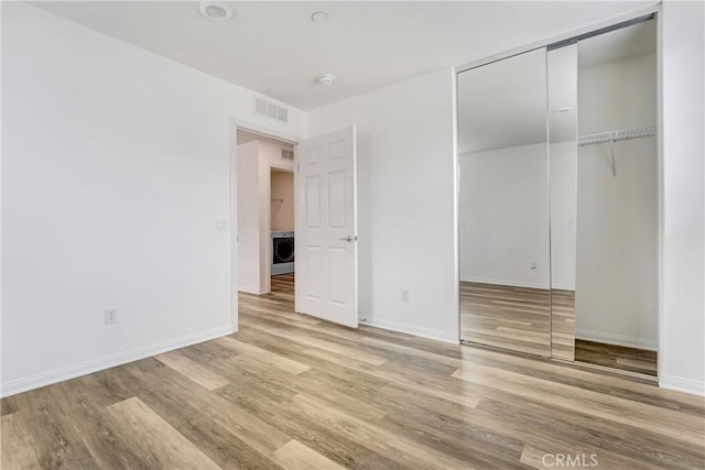 9126 Foster Ln, Chatsworth, CA 91311 - unfurnished bedroom with washer / dryer, wood finished floors, baseboards, and a closet