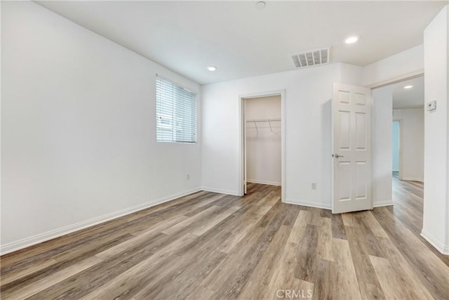 9126 Foster Ln, Chatsworth, CA 91311 - unfurnished bedroom with light wood-style floors, baseboards, a walk in closet, recessed lighting, and a closet