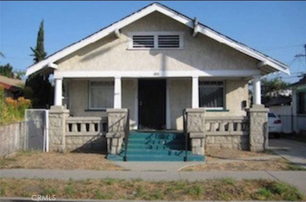 837 W Gage Ave, Los Angeles, CA 90044 - bungalow with stucco siding and a porch
