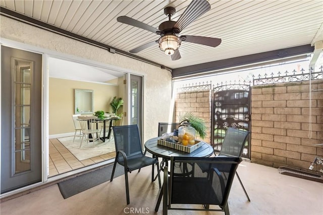 view of patio with outdoor dining area and a ceiling fan