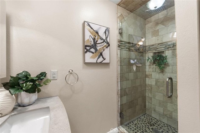 full bathroom with a stall shower and a sink