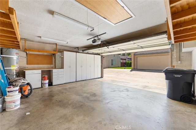 garage with a garage door opener and secured water heater