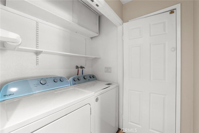 laundry area with washing machine and clothes dryer and laundry area