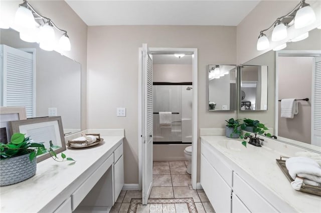full bath with enclosed tub / shower combo, baseboards, toilet, and vanity