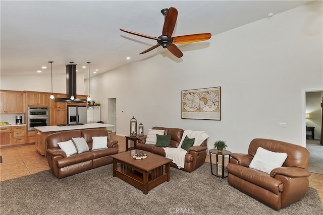 living area with ceiling fan, recessed lighting, high vaulted ceiling, and light carpet