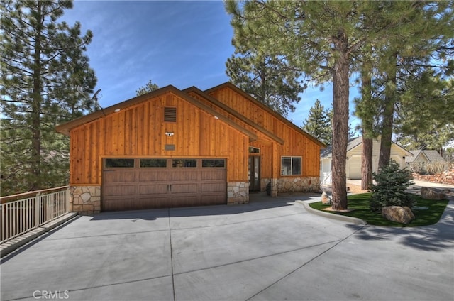 39080 Waterview Dr, Big Bear Lake, CA 92315 - view of front of home featuring stone siding, board and batten siding, a garage, and concrete driveway