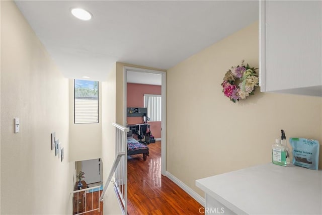 hall featuring baseboards and wood finished floors
