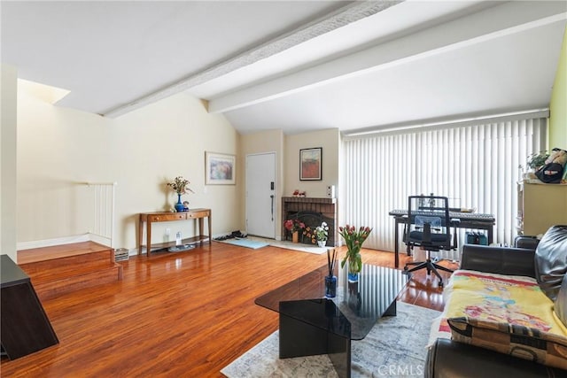 living room with lofted ceiling with beams and wood finished floors