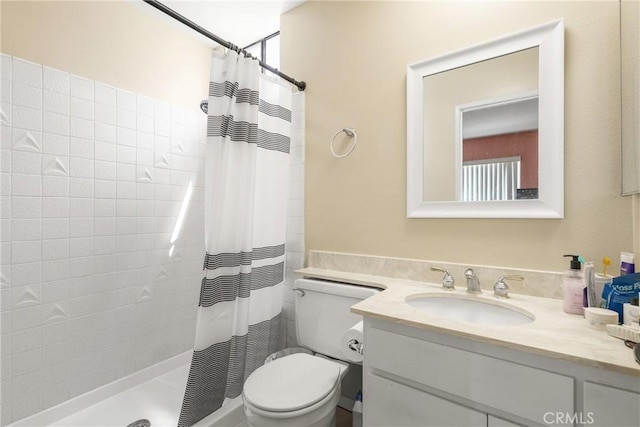 full bath with vanity, toilet, and tiled shower