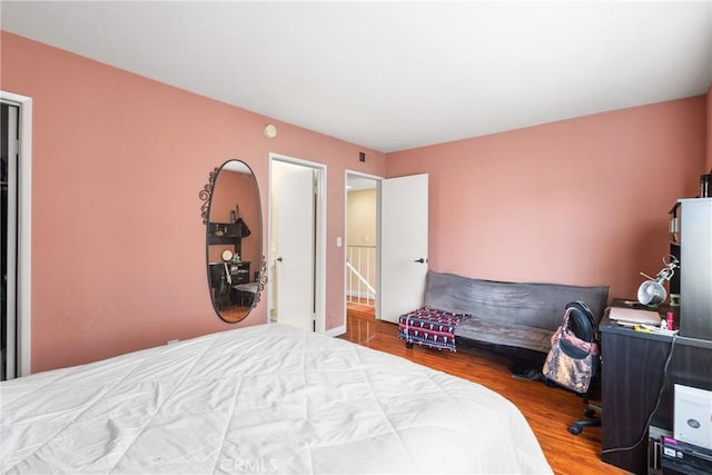 bedroom featuring wood finished floors and visible vents