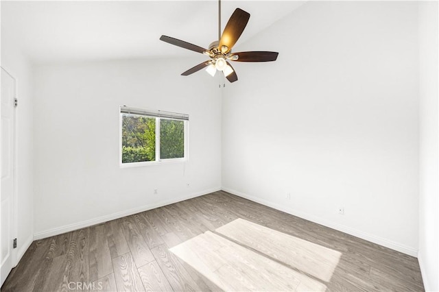 unfurnished room featuring a ceiling fan, baseboards, wood finished floors, and lofted ceiling