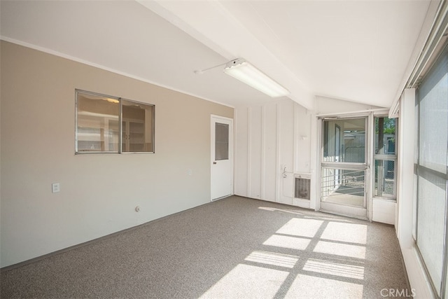 empty room with carpet and lofted ceiling