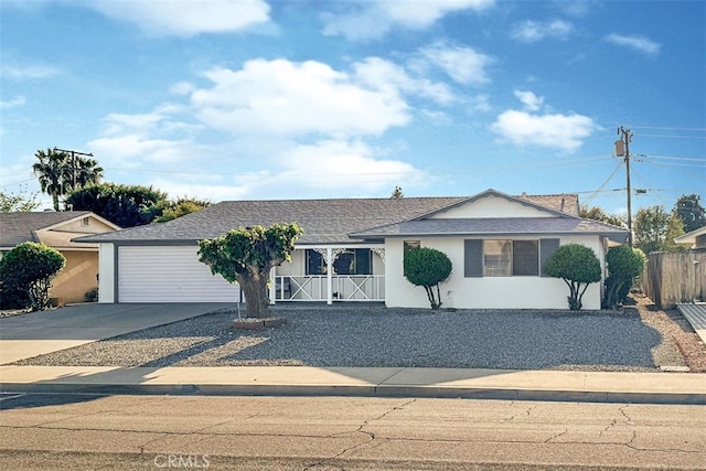 ranch-style house with driveway and fence