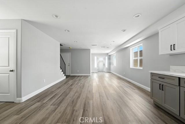 22020 Pioneer Blvd Unit A & B, Hawaiian Gardens, CA 90716 - unfurnished living room with light wood finished floors and stairway