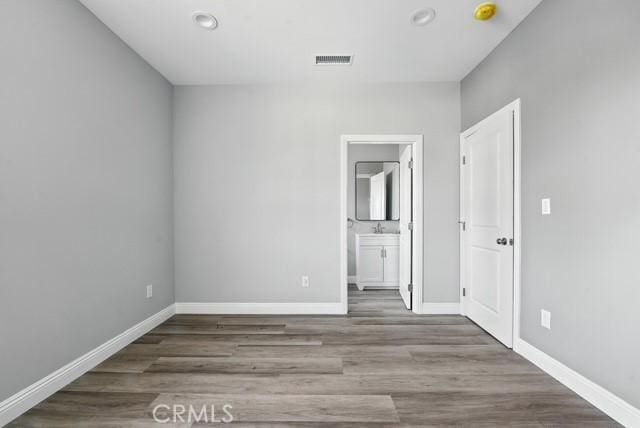 22020 Pioneer Blvd Unit A & B, Hawaiian Gardens, CA 90716 - unfurnished bedroom featuring wood finished floors, connected bathroom, and recessed lighting