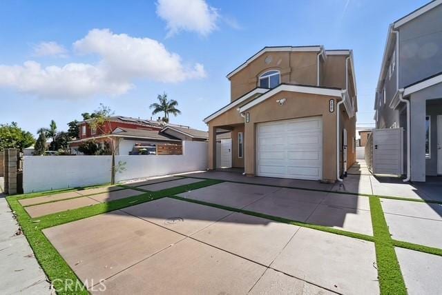22020 Pioneer Blvd Unit A & B, Hawaiian Gardens, CA 90716 - view of front of home featuring concrete driveway, stucco siding, and an attached garage