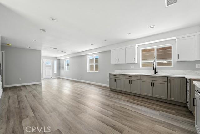 22020 Pioneer Blvd Unit A & B, Hawaiian Gardens, CA 90716 - kitchen with gray cabinets, light wood-style floors, open floor plan, light countertops, and recessed lighting