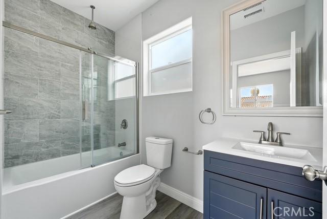22020 Pioneer Blvd Unit A & B, Hawaiian Gardens, CA 90716 - full bathroom featuring healthy amount of natural light, vanity, wood finished floors, and a combined bath / shower with rainfall shower
