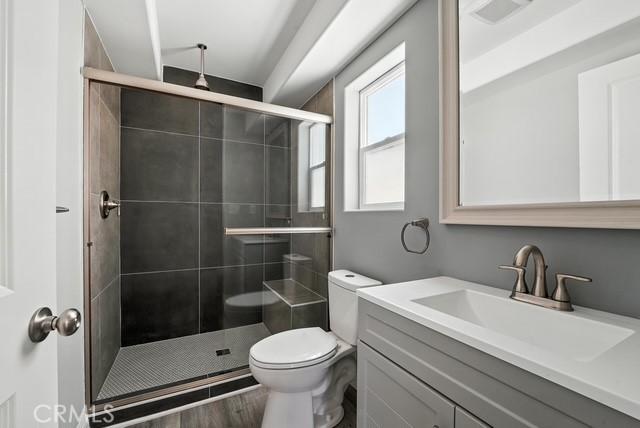22020 Pioneer Blvd Unit A & B, Hawaiian Gardens, CA 90716 - full bath featuring vanity, a shower stall, and wood finished floors