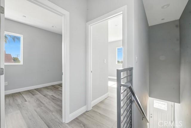 22020 Pioneer Blvd Unit A & B, Hawaiian Gardens, CA 90716 - hall featuring an upstairs landing, wood finished floors, and healthy amount of natural light