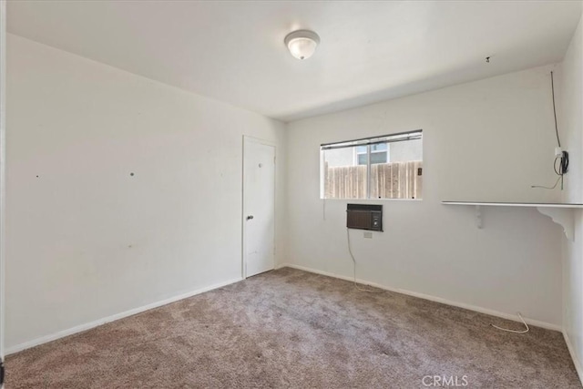 empty room featuring baseboards and carpet flooring