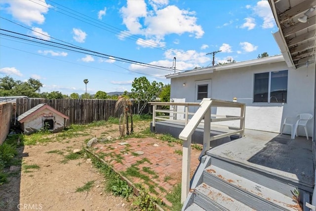 view of yard with a deck and a fenced backyard