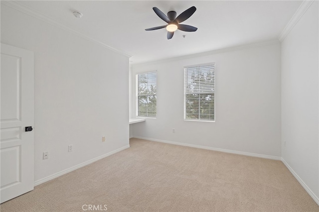 unfurnished room with crown molding, baseboards, a ceiling fan, and light colored carpet