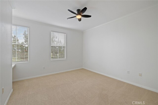unfurnished room with baseboards, ornamental molding, light carpet, and ceiling fan