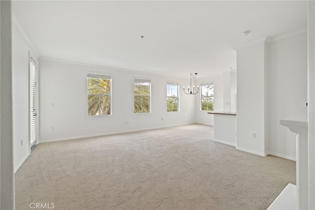 unfurnished room featuring baseboards, ornamental molding, a notable chandelier, and light carpet