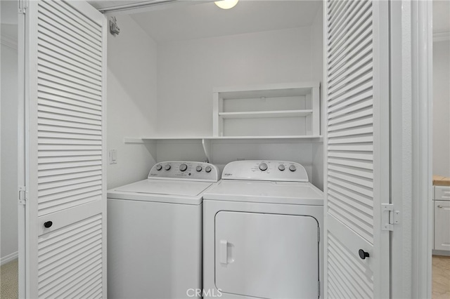 washroom featuring laundry area and washing machine and clothes dryer