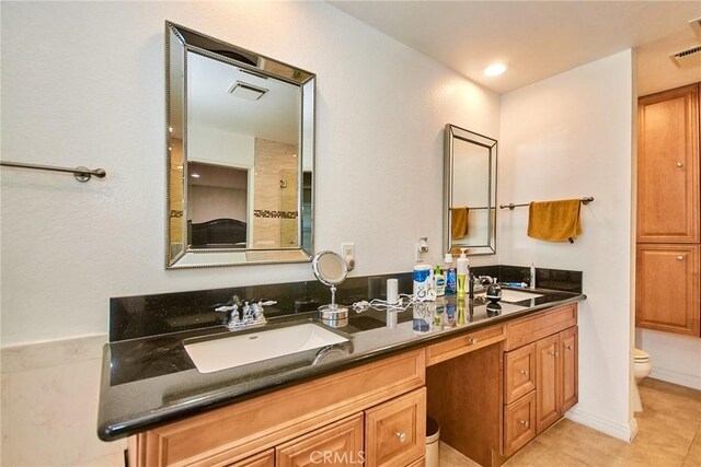 full bath with a sink, tile patterned flooring, double vanity, toilet, and visible vents