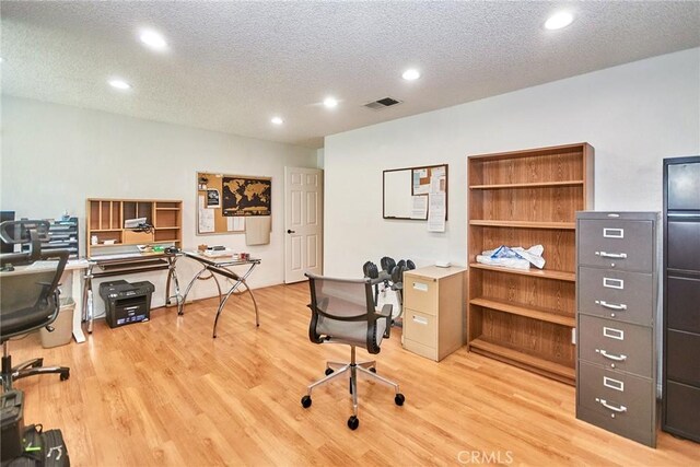 office area with recessed lighting, visible vents, and light wood-style flooring
