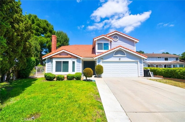 mediterranean / spanish house with fence, a front lawn, a tile roof, a garage, and concrete driveway