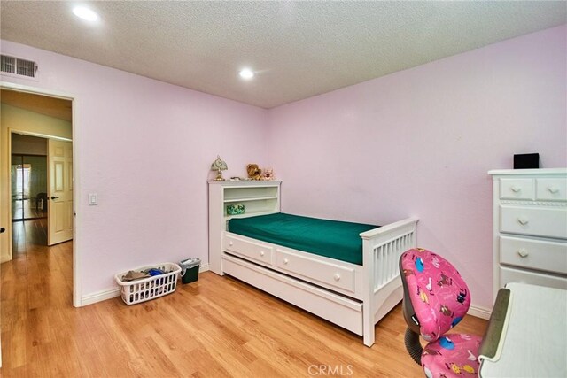 bedroom featuring recessed lighting, baseboards, visible vents, and light wood finished floors