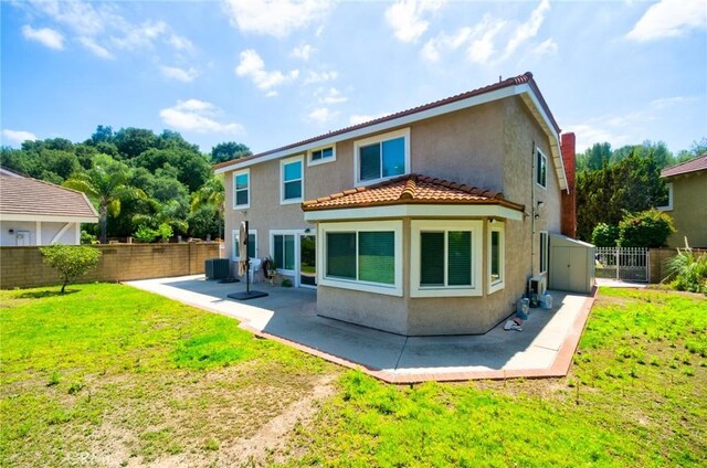 back of property with a patio area, fence, cooling unit, a yard, and stucco siding