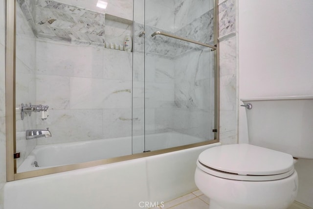 full bathroom with tile patterned flooring, combined bath / shower with glass door, and toilet
