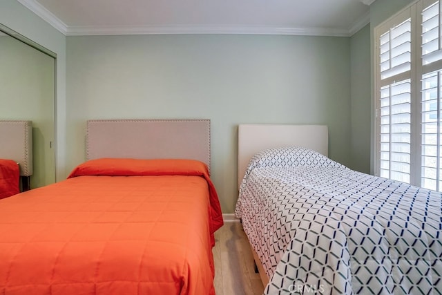 bedroom featuring crown molding and wood finished floors