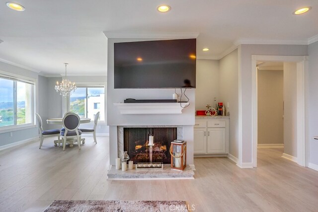 living room featuring crown molding, light wood-style floors, a chandelier, recessed lighting, and baseboards
