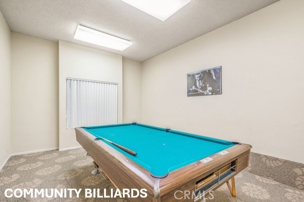 game room with baseboards, carpet flooring, and a textured ceiling