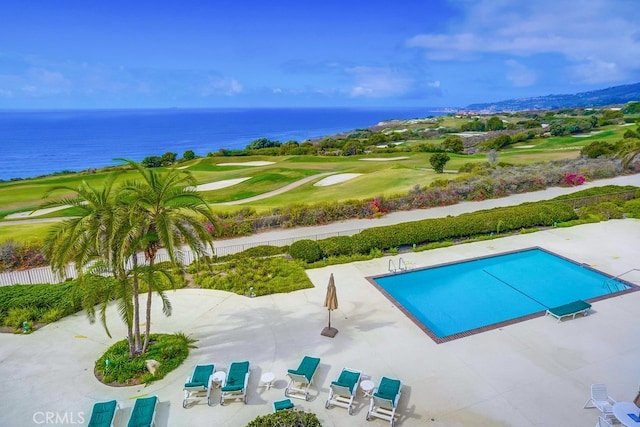 pool featuring a patio, a water view, and golf course view