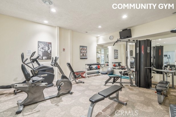 gym featuring carpet flooring, recessed lighting, and a textured ceiling