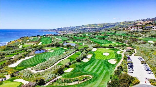 birds eye view of property with a water view and view of golf course