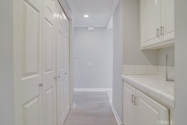 corridor with recessed lighting and baseboards