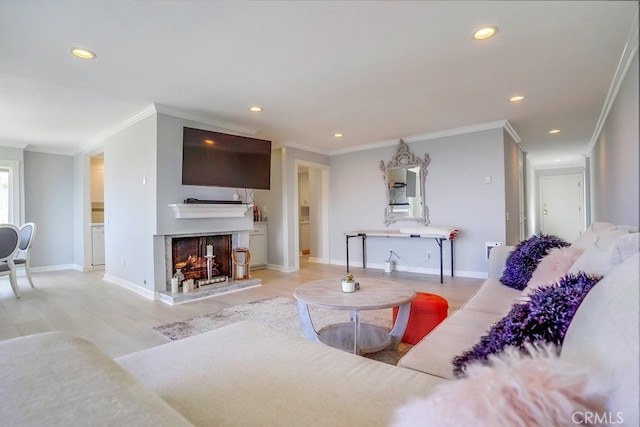 living area with a multi sided fireplace, wood finished floors, baseboards, ornamental molding, and recessed lighting