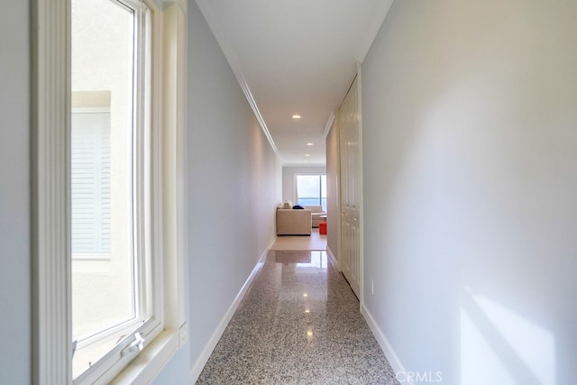 corridor with recessed lighting, baseboards, granite finish floor, and ornamental molding